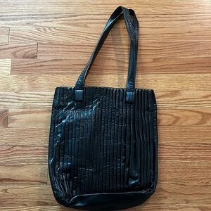 Women’s black leather pleated handbag